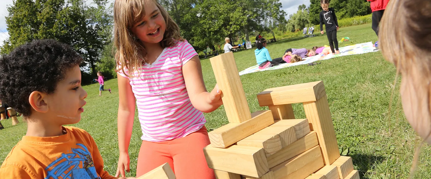 Group of children playing giant Jenga game