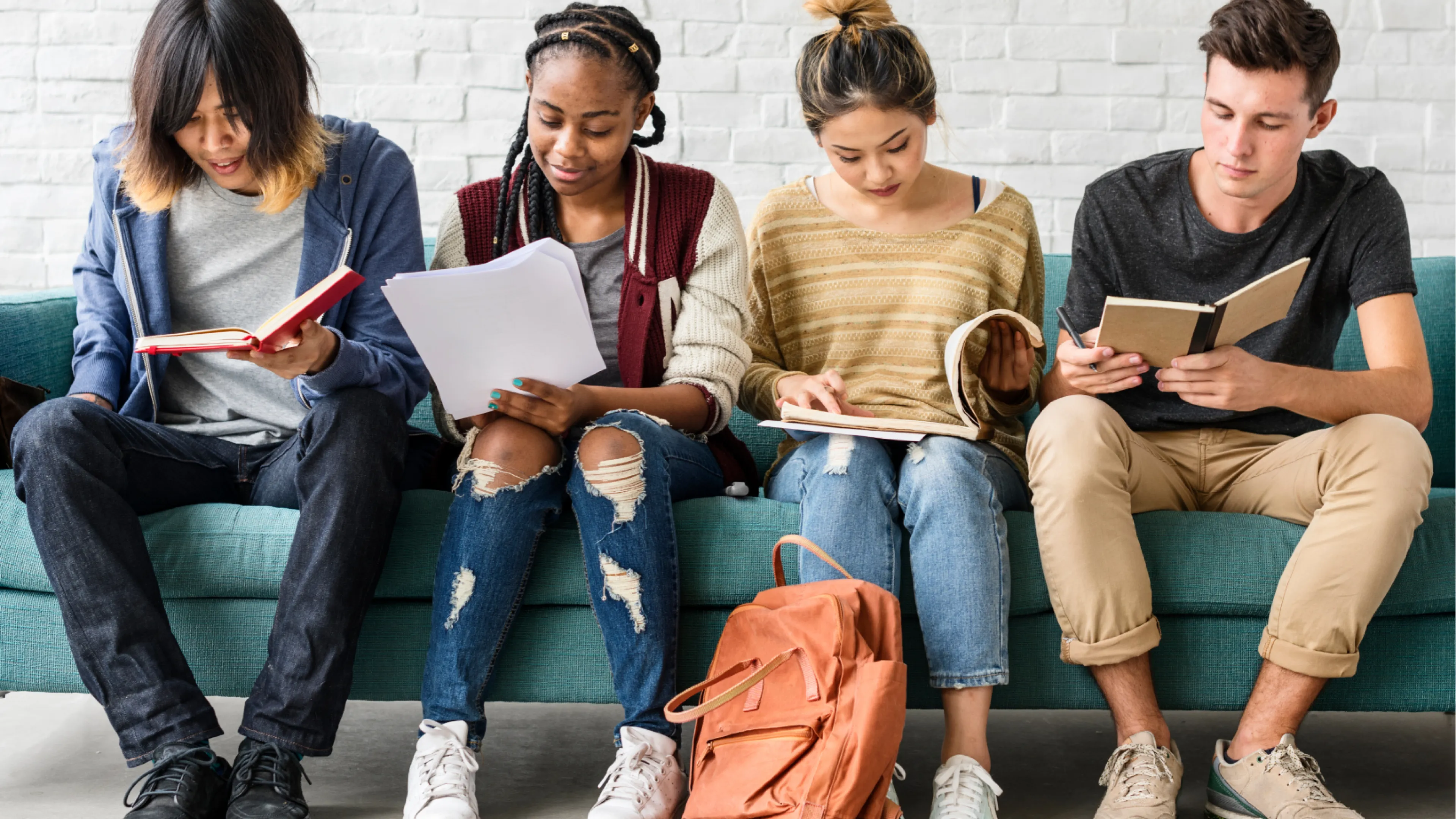 Youth looking at books studying