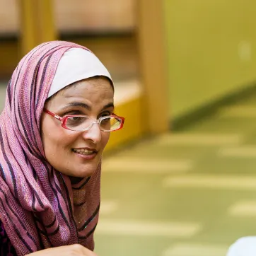 Immigrant woman in group conversation