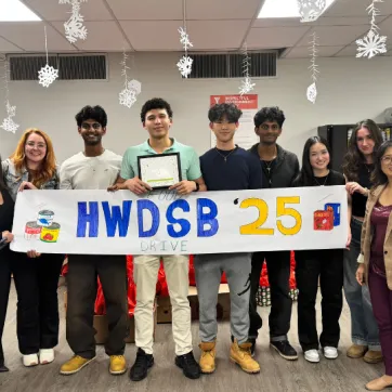 tudents tustees at HWDSB holding banner following foo drive.png