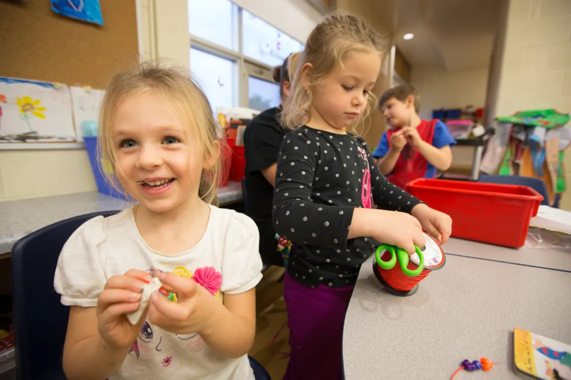 School age girls making crafts